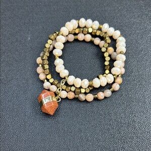Elegant Gold and Cream Beaded Bracelet with Sunstone Pendant